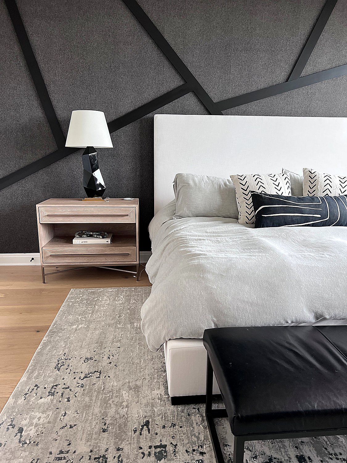 Real accent wall installation behind a bed by The Style Maison