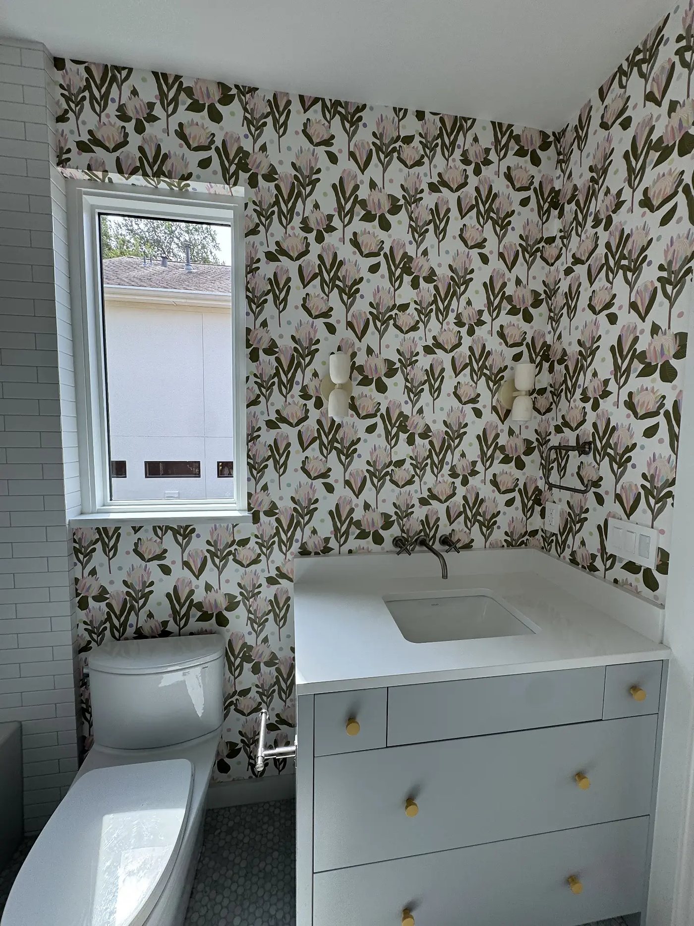 Bathroom with protea floral wallpaper, installed by The Style Maison