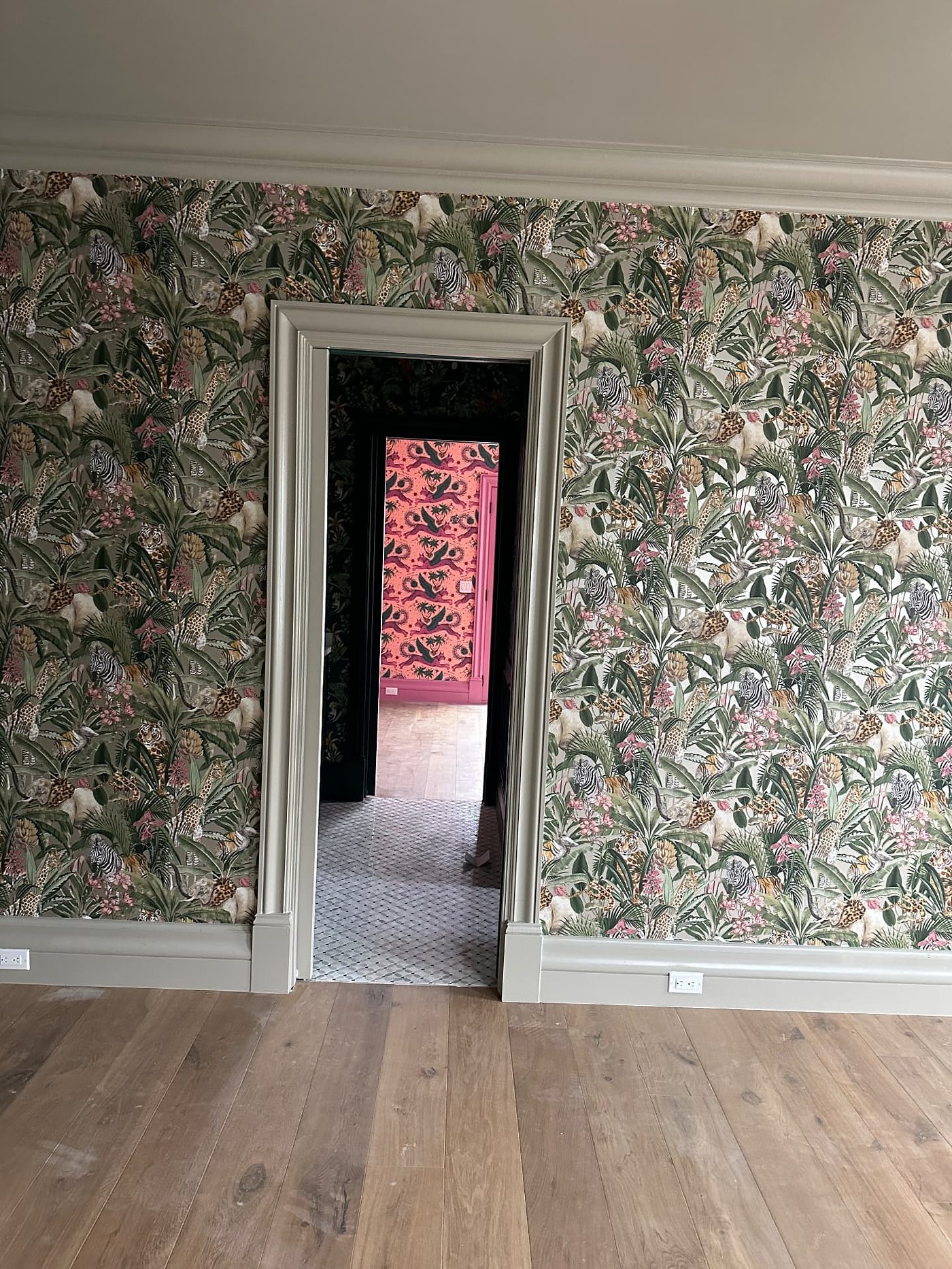 Dining room with a jungle print wallpaper, installed by The Style Maison