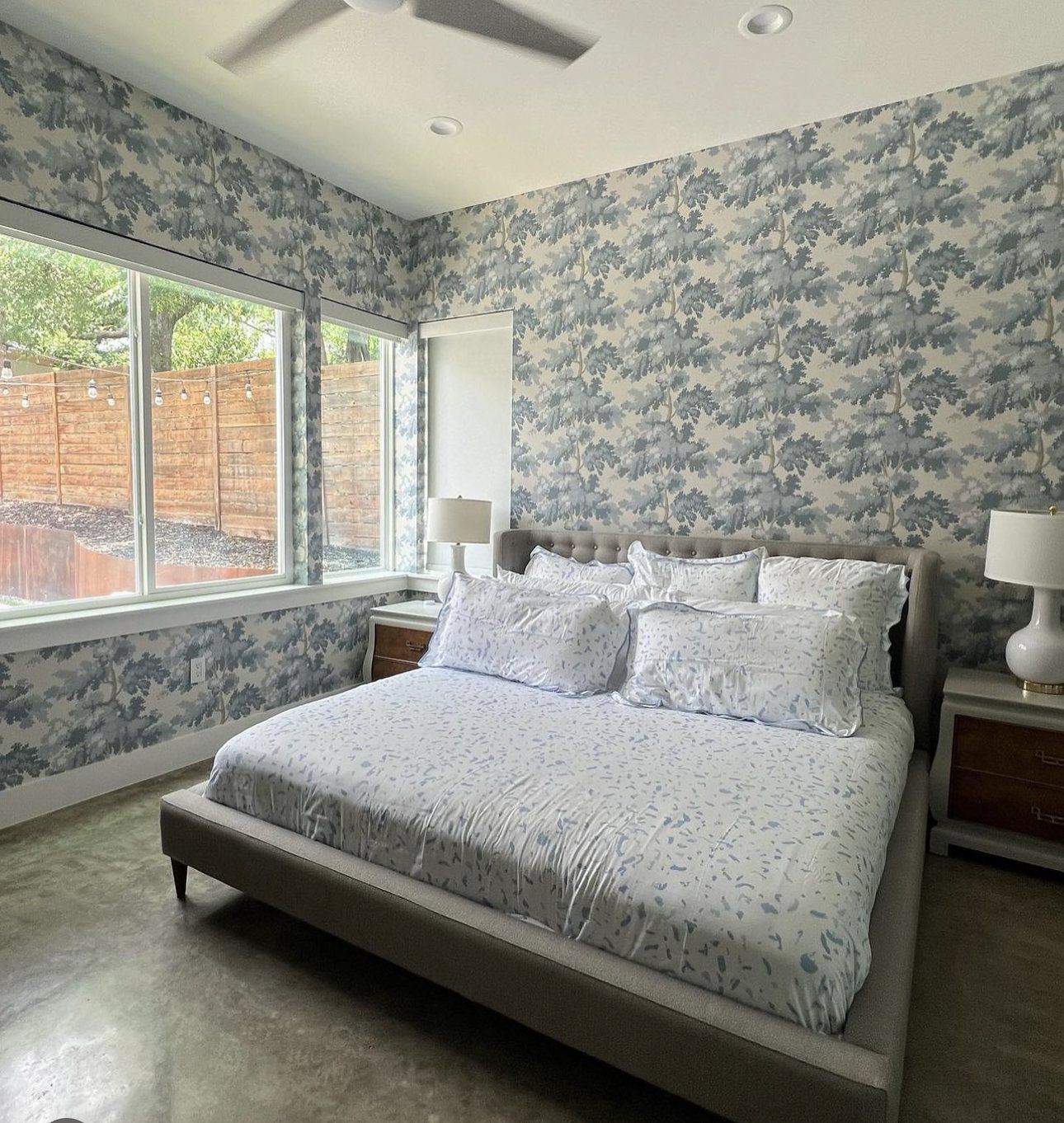 Bedroom with a tree pattern wallpaper, installed by The Style Maison