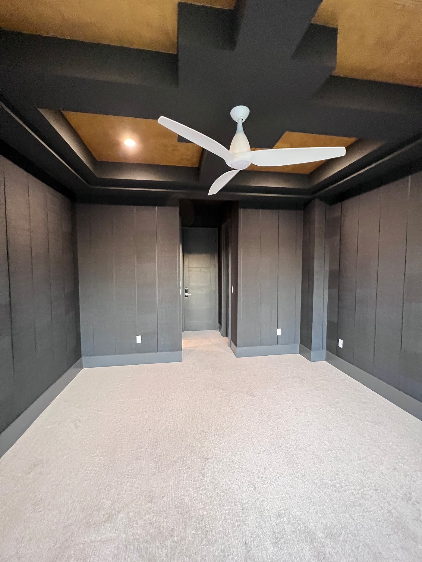 Media room with a textured wallcovering, installed by The Style Maison