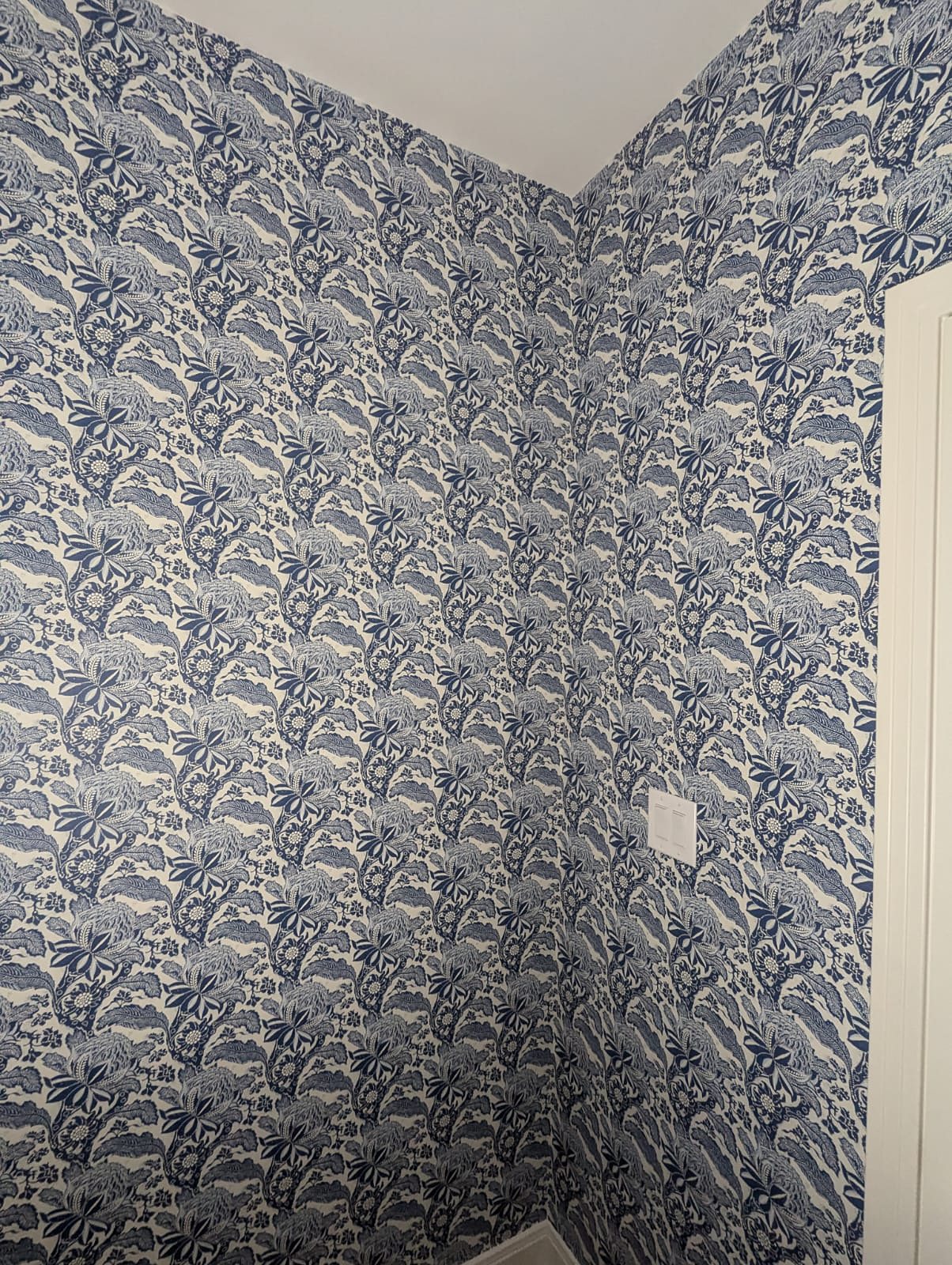 Powder room with indigo floral wallpaper, installed by The Style Maison