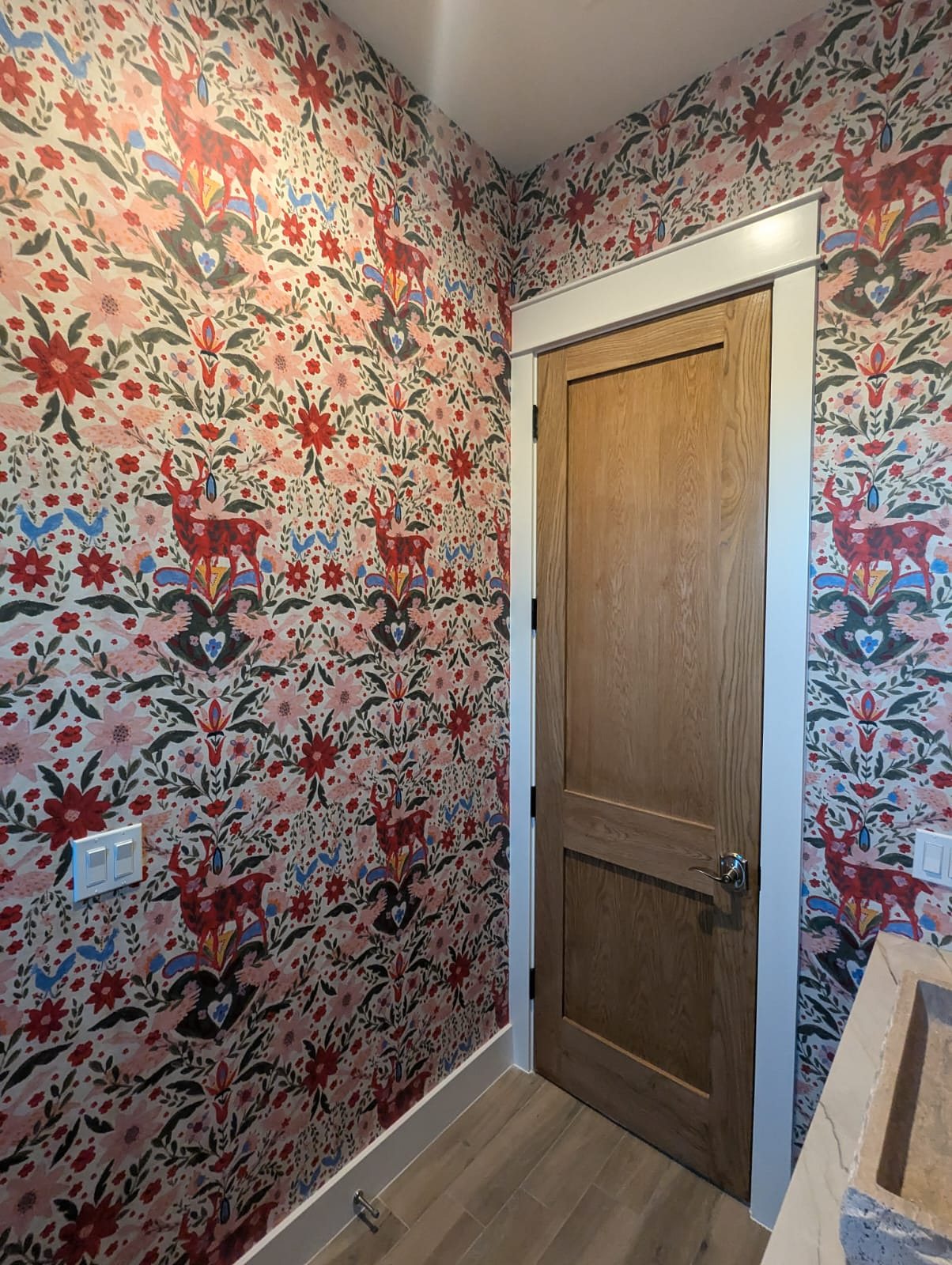 Powder bath with folk floral wallpaper, installed by The Style Maison