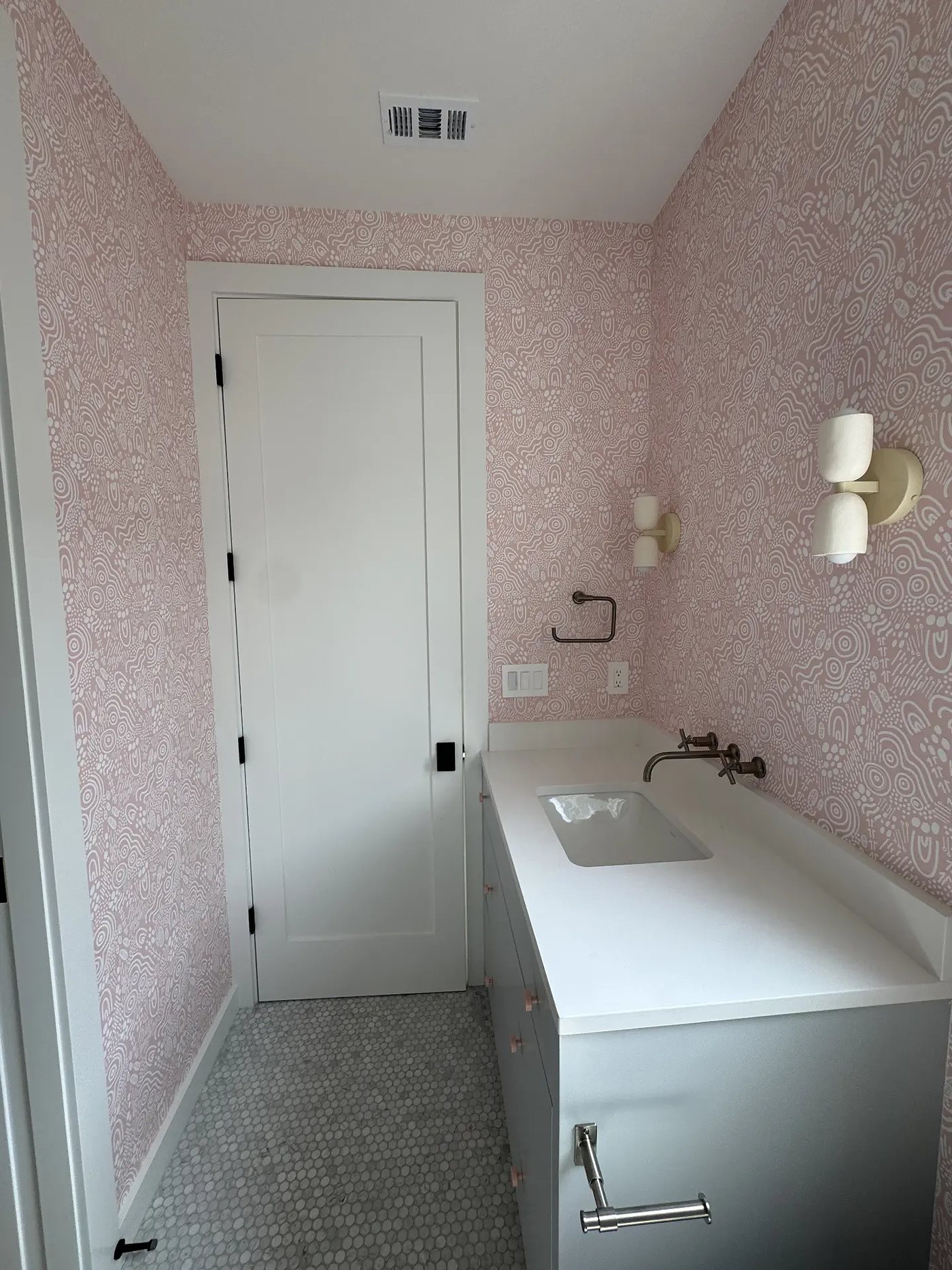 Powder bath with blush pattern wallpaper, installed by The Style Maison