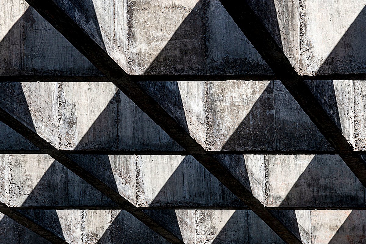Light and shadow across a concrete wall
