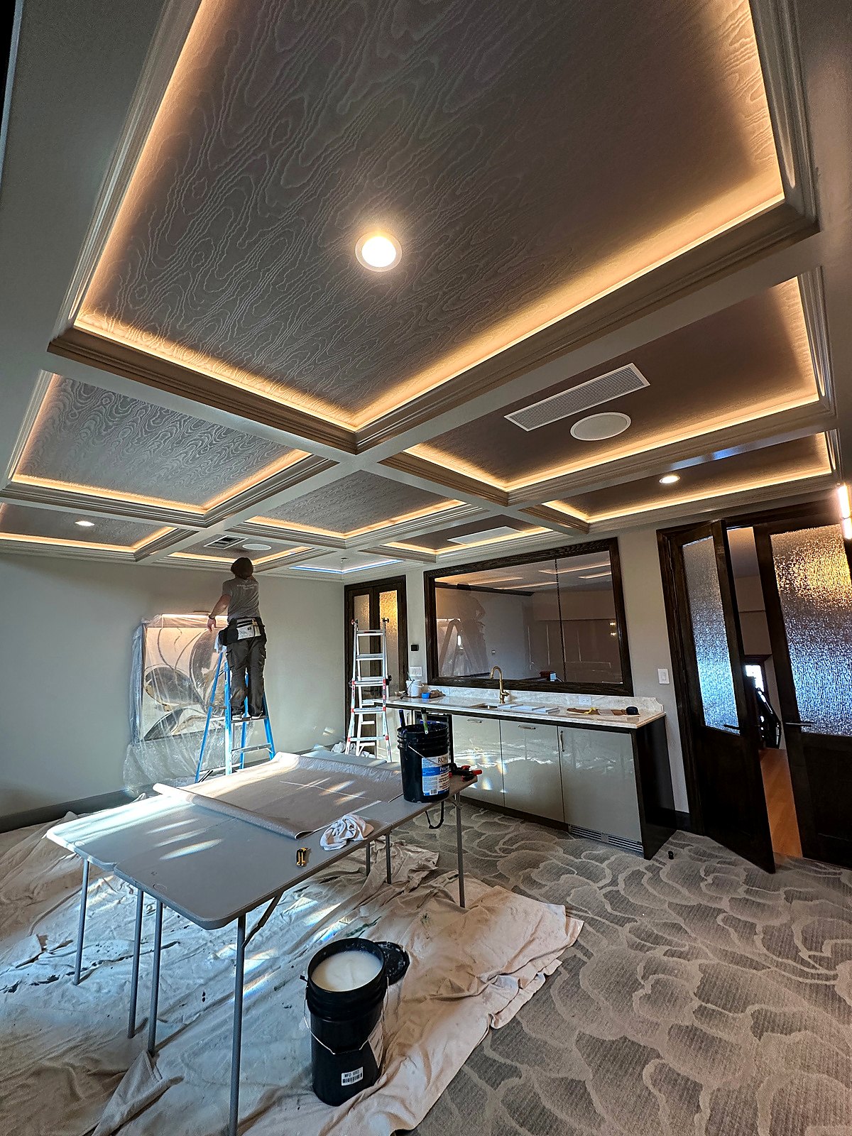 Commercial space with a coffered ceiling and wallcovering in progress