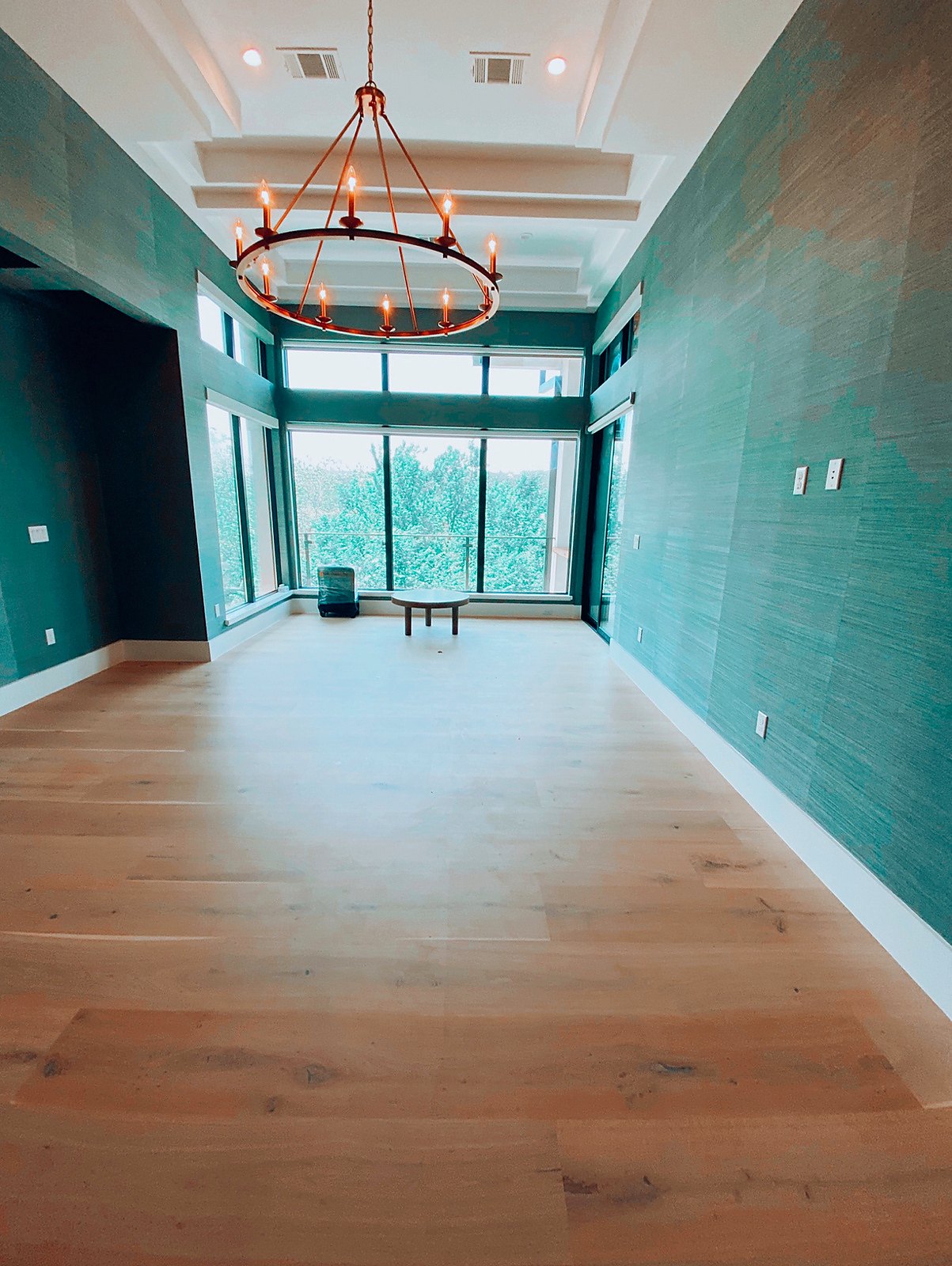 Grasscloth-covered walls in a teal primary suite, a real Style Maison installation