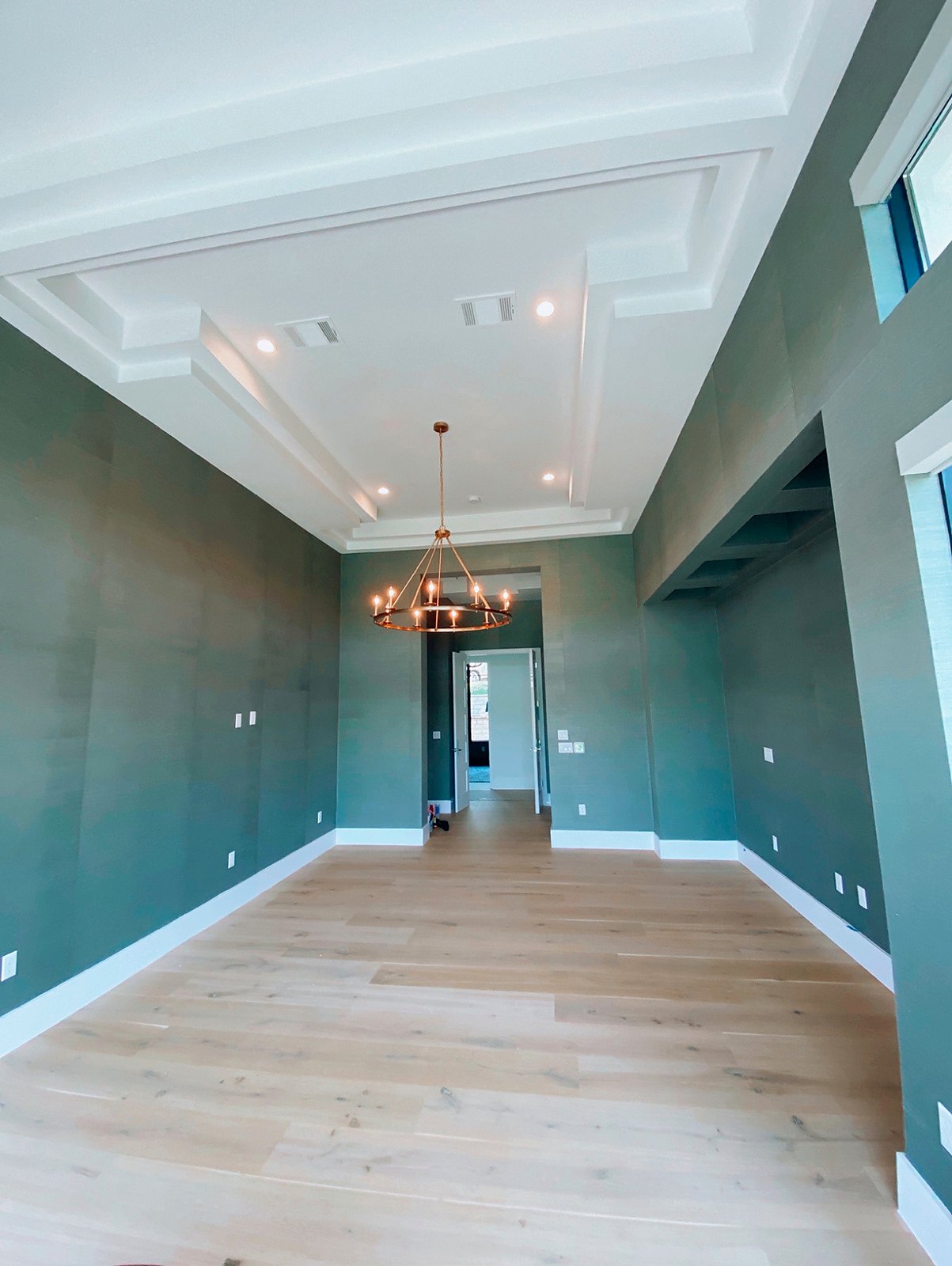 Grasscloth walls in a suite with a coffered ceiling