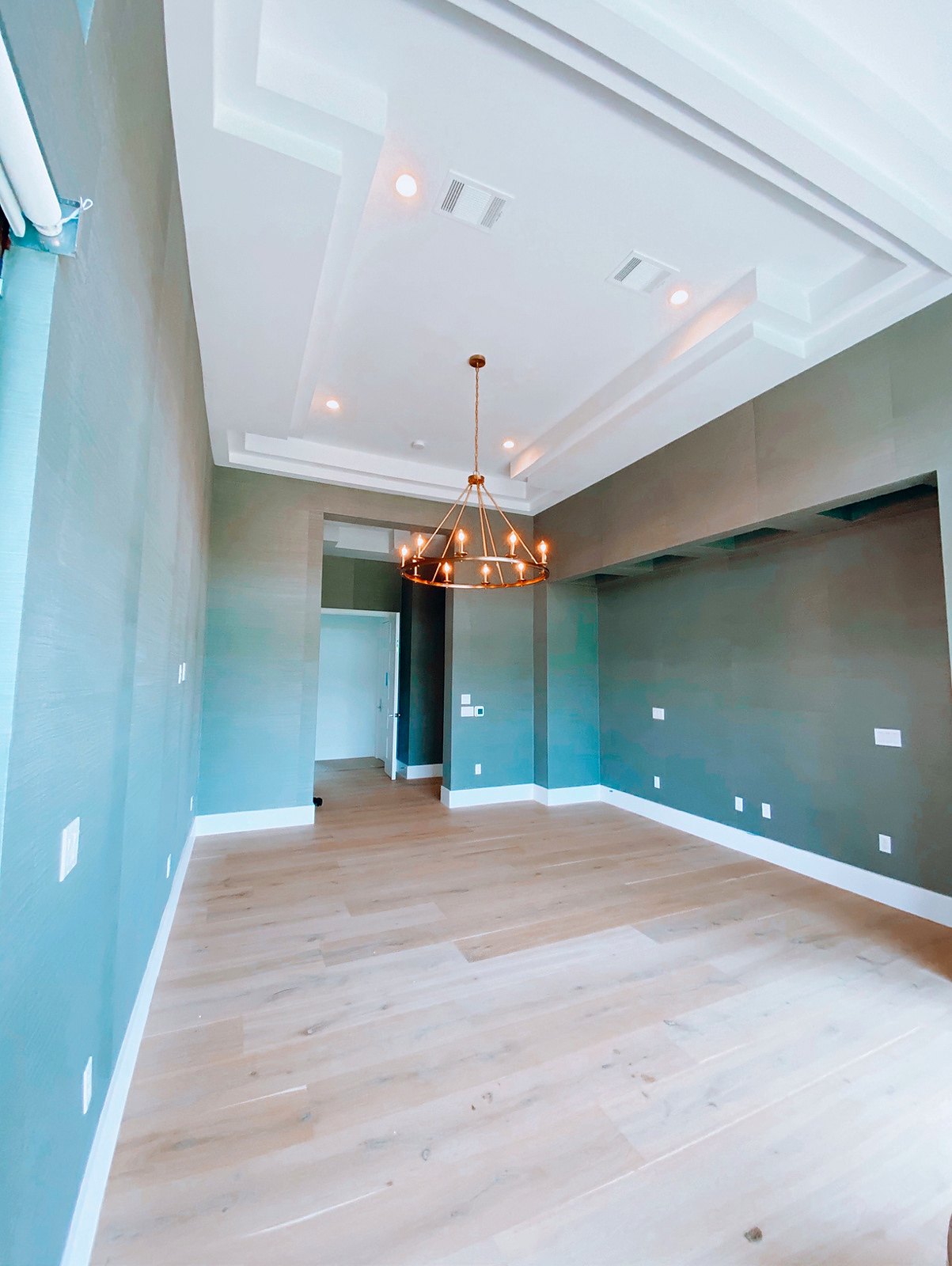 Grasscloth walls running into a hallway of a custom home