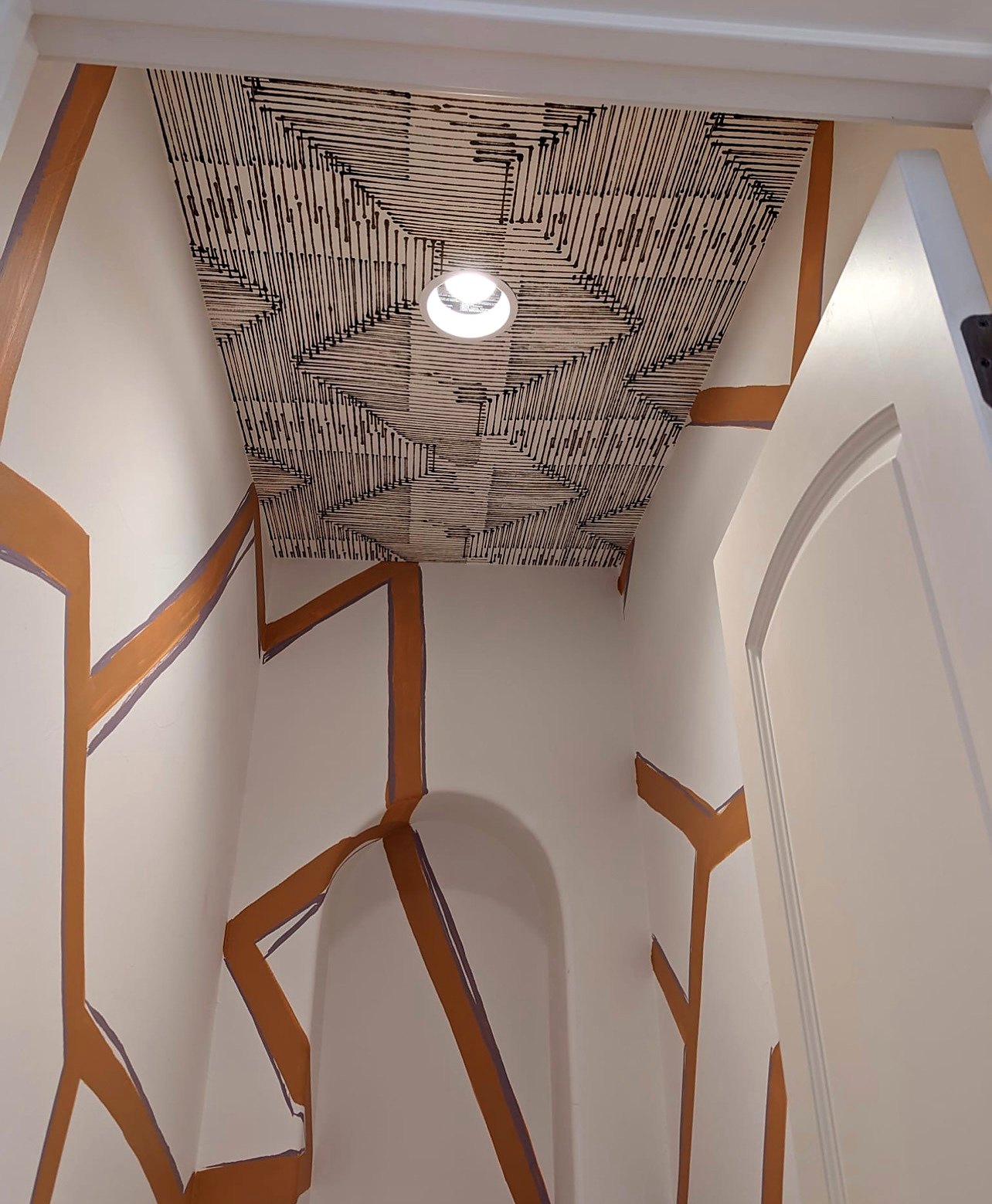 Patterned wallpaper on a ceiling with painted copper accents in a small space, a real Style Maison project