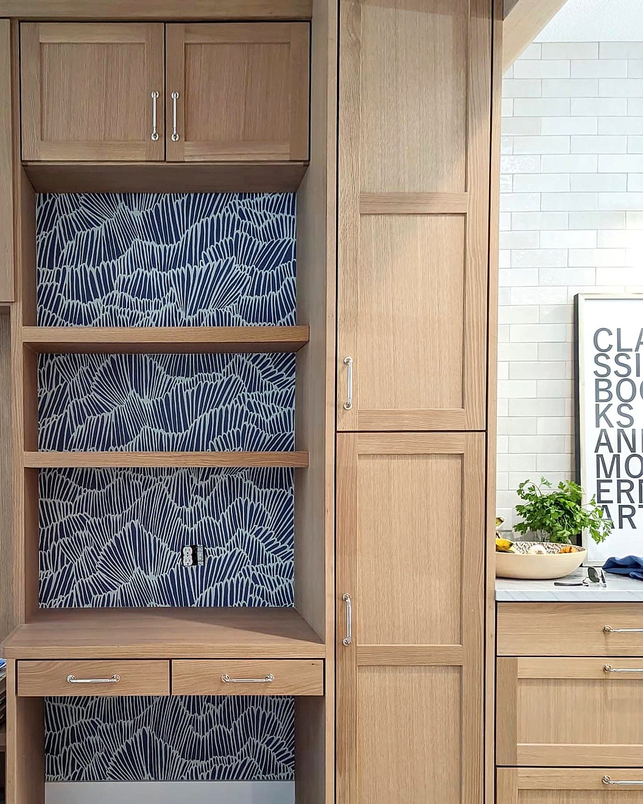Blue patterned wallpaper lining built-in cabinet niches
